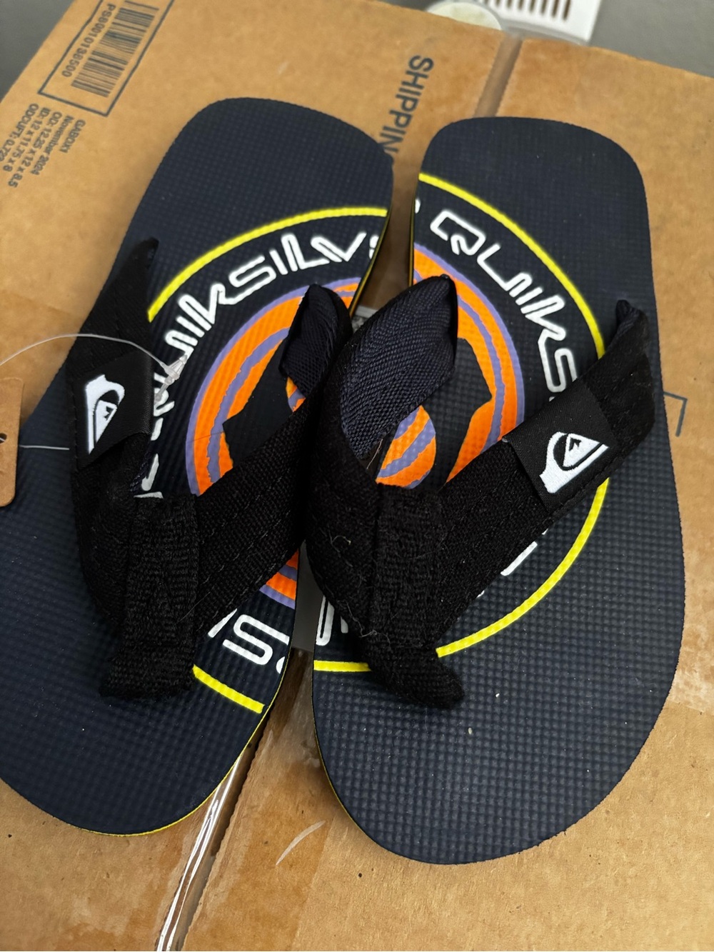 Quiksilver Kids Black Flip Flops with Orange and Yellow Logo